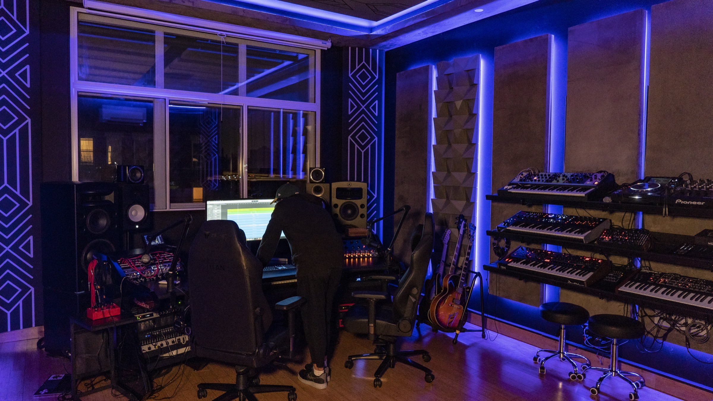 A late session at Antenna Studios — Tim working over the desk under blue light